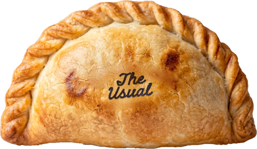 A golden empanada stamped The Usual